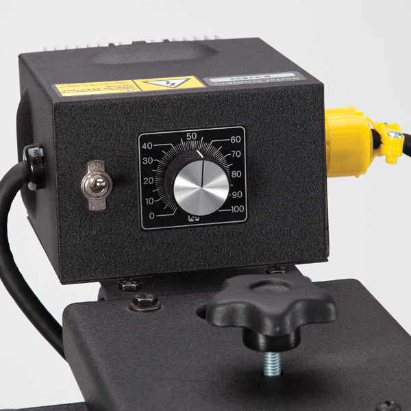 Black control panel with a dial and yellow plug on a white background