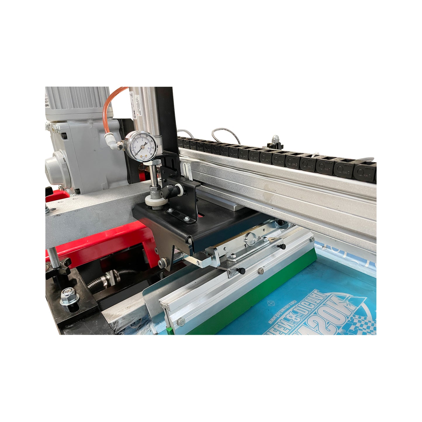 The motor-driven print head and pneumatic squeegee system of a Lawson M-Series clamshell press, featuring a precision pressure dial for consistent ink application on flatstock and garments.