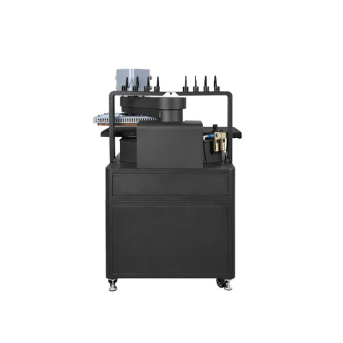 Black industrial machine with various components on a white background