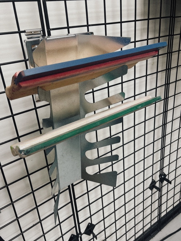 Wall-mounted aluminum squeegee rack holding six screen printing squeegees.